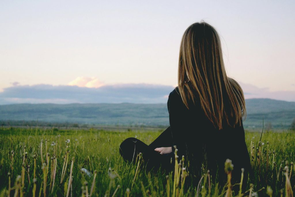 Woman sitting in a field.