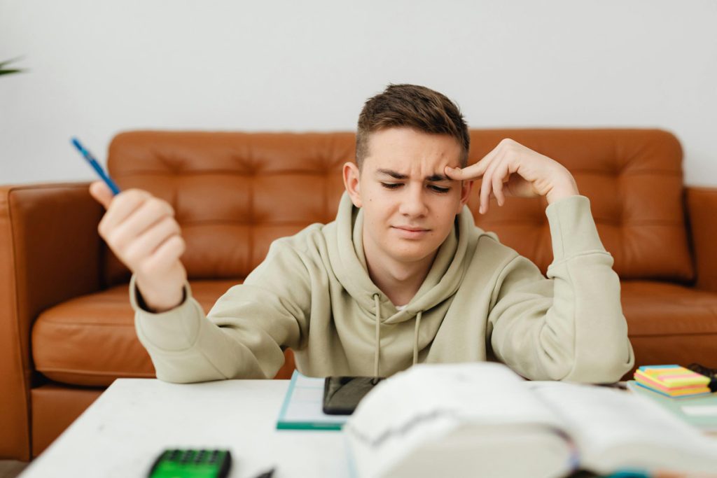 stressed college student reading textboox