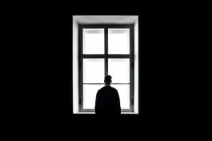 man alone in window