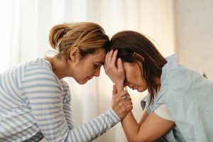 Two female friends offering support and comfort.