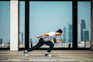 Man running in front of city skyline