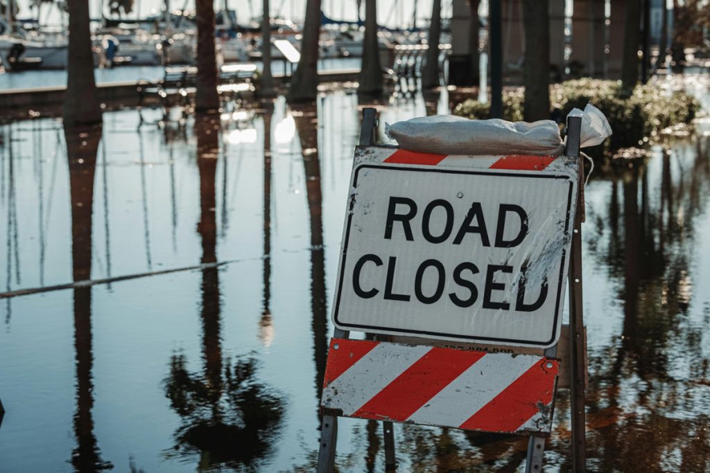 Road Closed sign in floodwater.