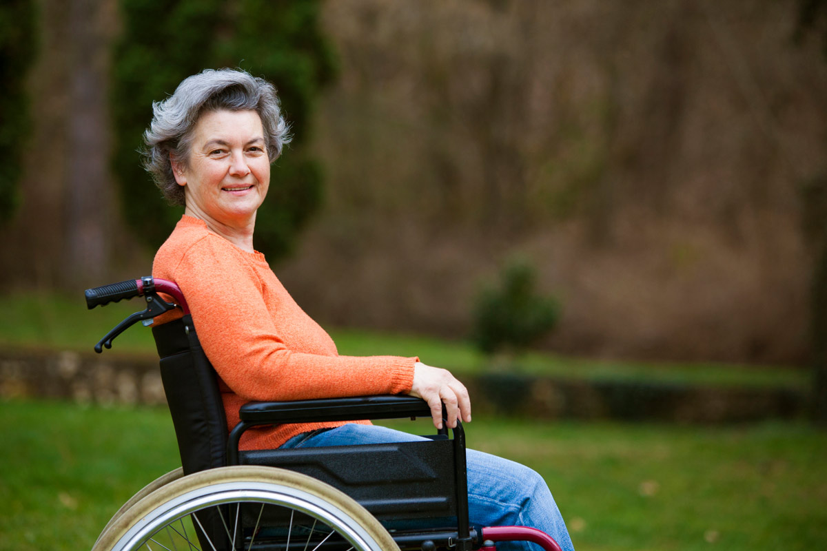 woman in courtyard in a wheelchair