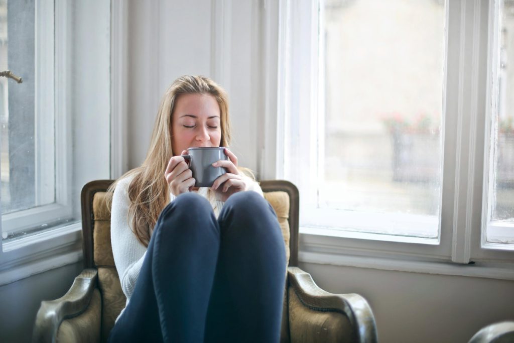 Relaxed woman sipping from a cup.