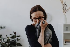 Grieving woman holding a mens sports jacket.