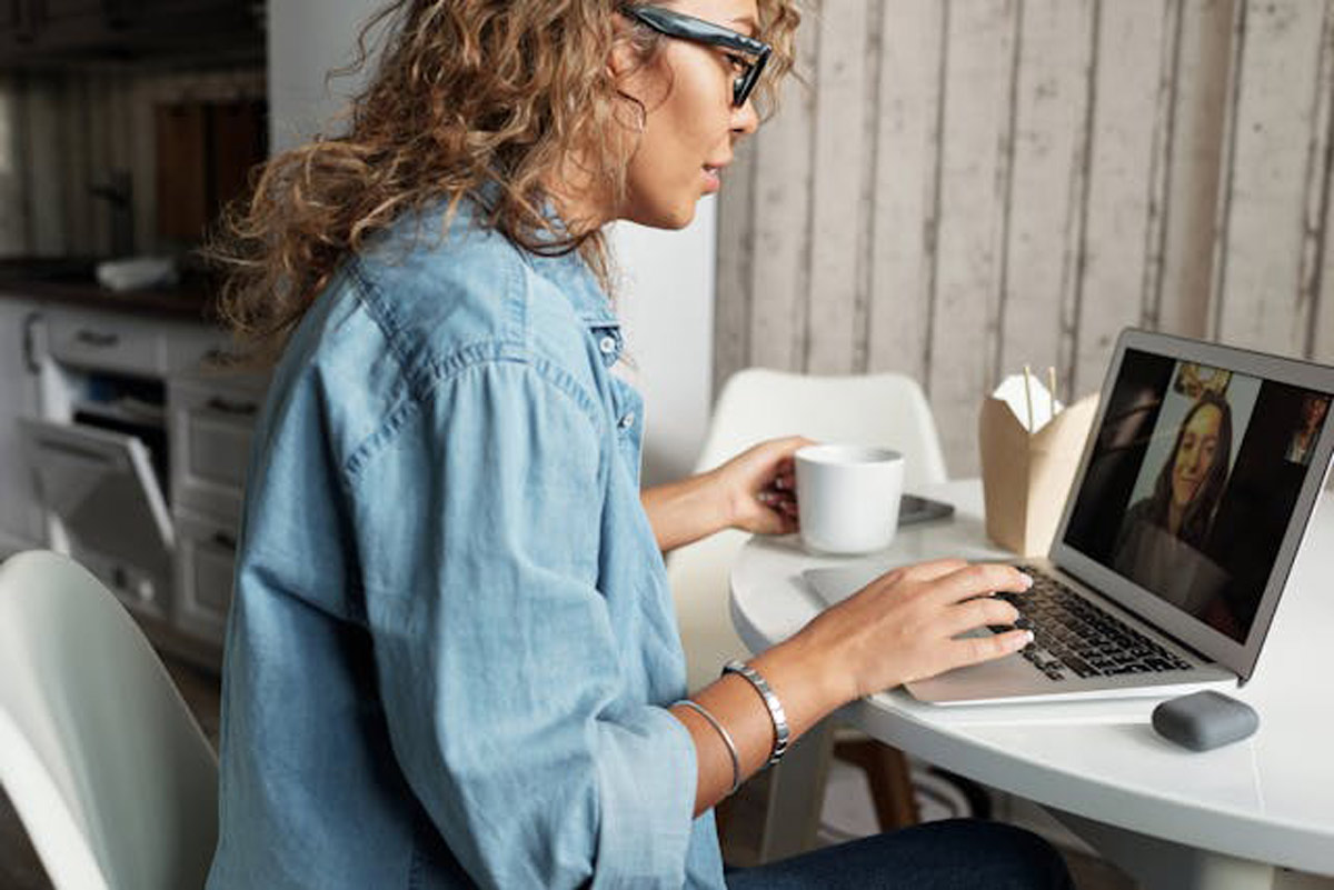 A woman talking with her friend via video call.