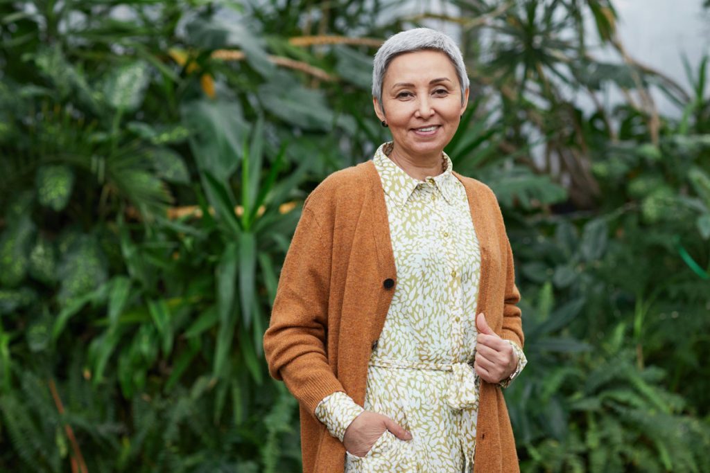 Smiling senior citizen standing outside