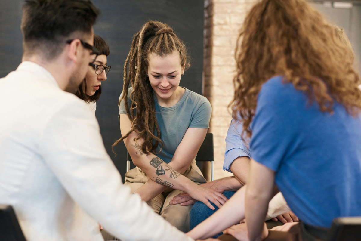 People holding hands in a support group.